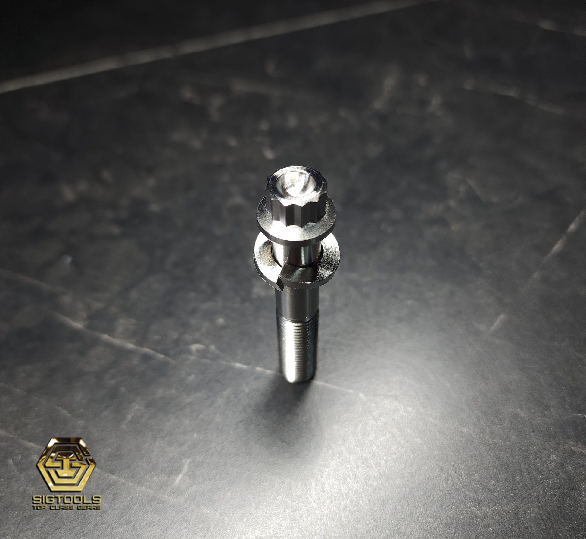 Top view photograph of a Martinez 12-point Titanium Replacement Bolt with Washer designed for M1 and M4 Steel Heads.