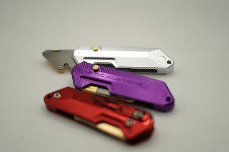 The Kinetic Customs 'The Reaper' BR-1 utility tool, showcasing its machined aircraft-grade aluminium scales and brass inserts.