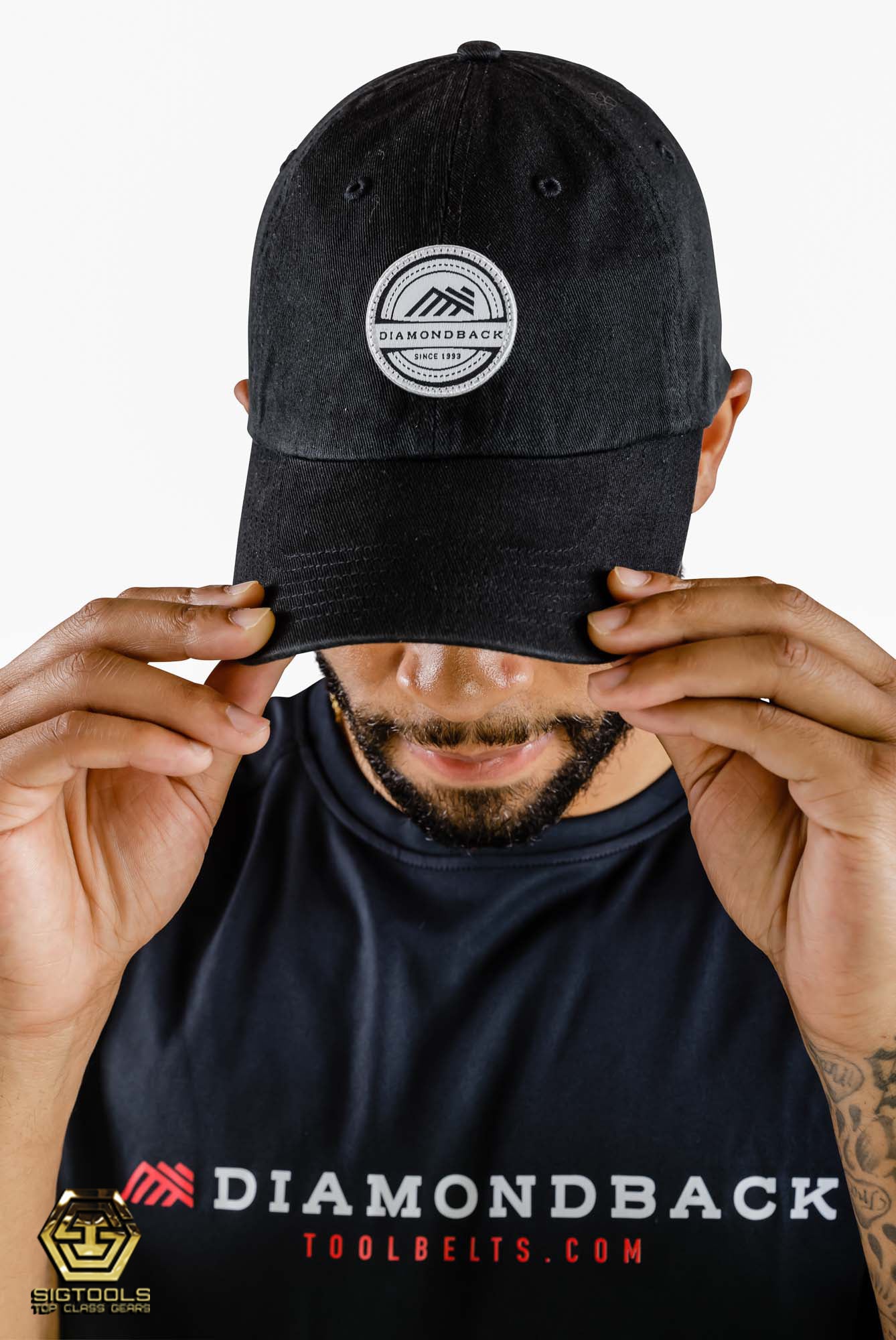 A person wearing a Diamondback Black and white dad hat with the brand's logo on the front, showcasing the hat's style and fit when worn
